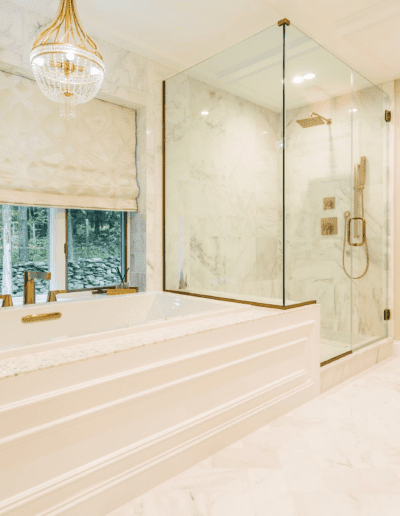 A white bathroom with a glass shower door.