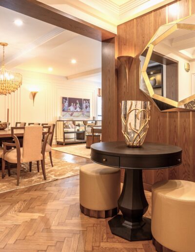 A dining room with wood paneling and gold accents.